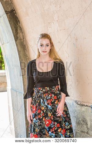Young American Teenage College Student With Long Blonde Hair, White Skin, Wearing Black Long Sleeve 