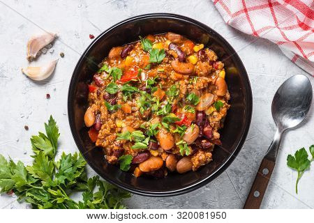 Chili Con Carne From Meat, Beans And Vegetables In Black Plate On Stone Table. Traditional Mexican F