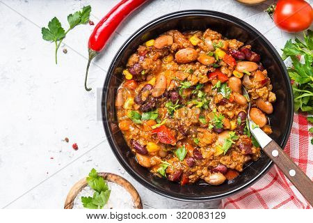 Chili Con Carne From Meat, Beans And Vegetables In Black Plate On Stone Table. Traditional Mexican F