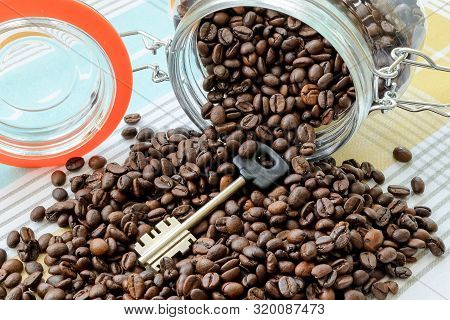 Large Key And Coffee Beans Was Scattered From Fallen Glass Jar On A Tablecloth. Can For Bulk Food Pr