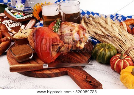 Traditional German Cuisine, Schweinshaxe Roasted Ham Hock. Beer, Pretzels And Various Bavarian Speci
