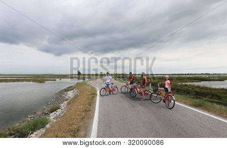 Happy Family On The Bike In Summer In The Plain