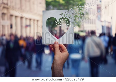 Health And Wellbeing Global Issue As Human Hand Holding A Paper With Heart Symbol Breaking Into Piec
