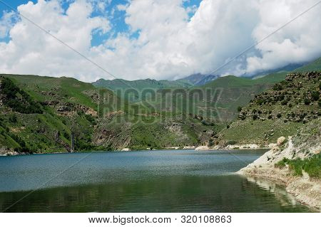 Beautiful Landscape Overlooking The Blue Lake In The Mountains. Lake Giggit In The Region Of Elbrus
