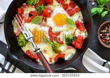 Fried Eggs With Tomatoes, Peppers And Broccoli For Breakfast On The Kitchen Table. Good Morning.