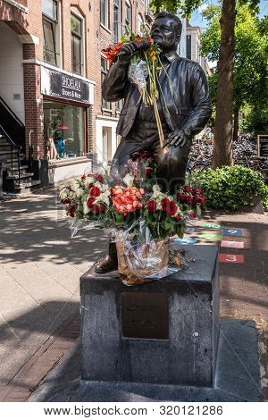 Amsterdam, The Netherlands - July 1, 2019: André Hazes Singer Songwriter, Bronze Statue With Bouquet