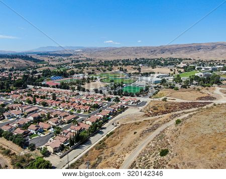 Aerial View Of Small Neighborhood With Dry Desert Mountain On The Background In Moorpark, Ventura Co