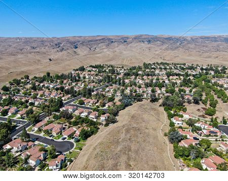 Aerial View Of Small Neighborhood With Dry Desert Mountain On The Background In Moorpark, Ventura Co