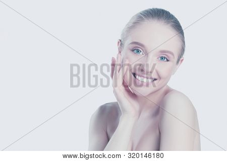 Portrait Of Beautiful Woman With Natural Make Up Touching Her Face.