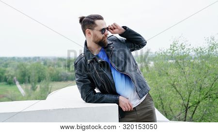 Side View Fashion Portrait Of Thinking Stylish Young Handsome Bearded Hipster Man In Sunglasses Look