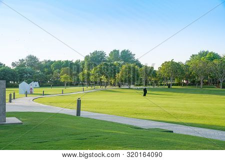 Doha Qatar - July 10 2019; The Corniche Park And Public Artworks. With Small Figure Of Muslim Woman 