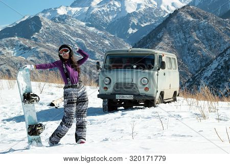 Almaty, Kazakhstan - January 10, 2019: Uaz 452 4x4 And Snowboard Burton Girl In Tian-shan Mountain O