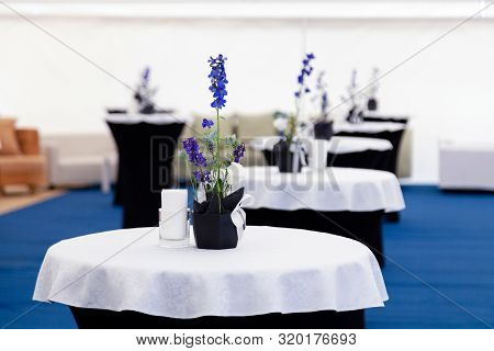 Catering, High Buffet Tables With A Black And White Tablecloth In Lobby, Large Tent With Blue Floor.