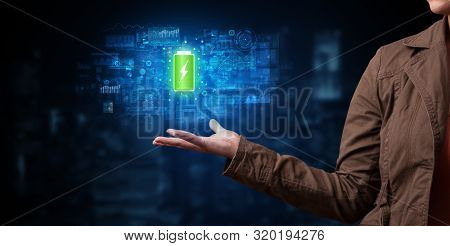 Elegant hand holding battery with full of energy