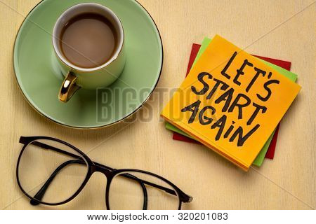 let us start again motivational reminder note with a cup of coffee, determination and tenacity concept