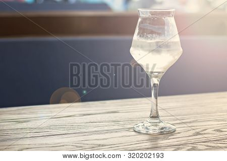 A Glass Of Cold White Wine On The Table On The Terrace Of A Summer Cafe. A Glass Of White Wine On Th