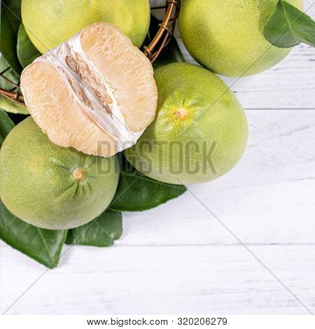Fresh Peeled Pomelo, Grapefruit, Shaddock With Green Leaf On Bright Wooden Plank Table. Seasonal Fru