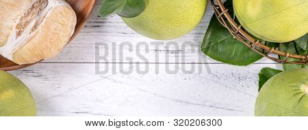 Fresh Peeled Pomelo, Grapefruit, Shaddock With Green Leaf On Bright Wooden Plank Table. Seasonal Fru