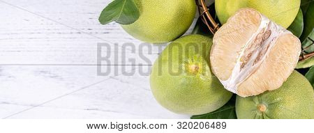 Fresh Peeled Pomelo, Grapefruit, Shaddock With Green Leaf On Bright Wooden Plank Table. Seasonal Fru