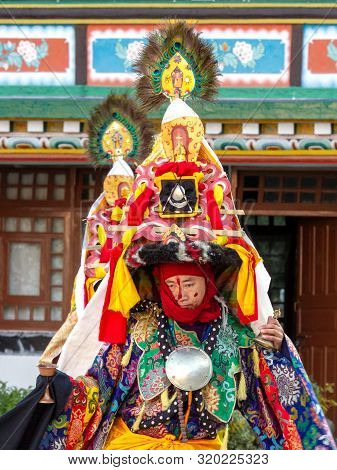 Lingdum, Sikkim, India - December 23, 2011: Lama In Ritual Costume And Ornate Hat Performs A Histori