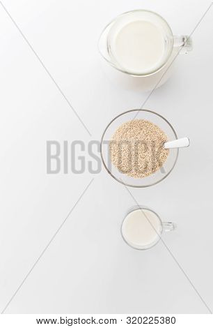 Vegan Non Diary Milk From Sesame Seeds  In The Glass Cup  And In The Pitcher On Light  Background. S