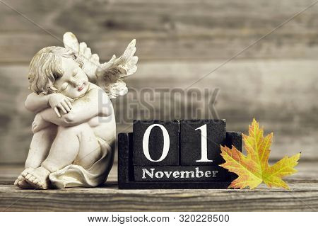 All Saints Day. Angel, Wooden Calendar And Yellow Autumn Leaf