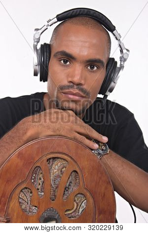 African musician singer with headphones holding a vintage radio