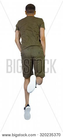 Back view of man in zero gravity or a fall. guy is flying, falling or floating in the air.  Isolated over white background. A guy in shorts hung in zero gravity with his hands in his pockets.