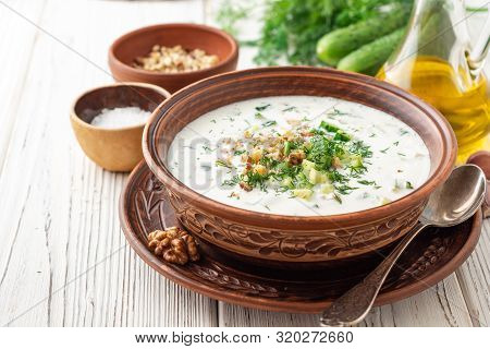 Traditional Bulgarian Cold Summer Soup Tarator With Yogurt, Dill, Cucumber And Walnuts In Ceramic Bo