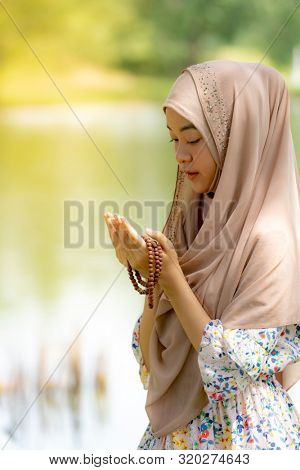 Young Adult teenager Woman making Duas for Muslim god blessing prayer.