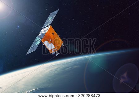Space Satellite Orbiting Earth Low Polar Orbit. Bright Light From The Sun And Glare In The Frame. El