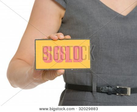 Closeup On Sold Sign In Female Hand Isolated