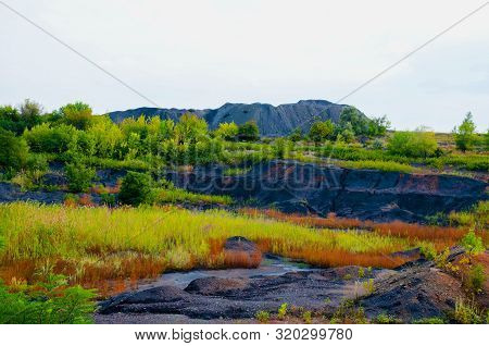 The Industrial Landscape Consists Of Sludge Sump And Sludge Dumps.