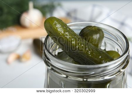 Jar With Pickled Cucumbers On Table, Closeup View