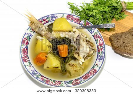 Ready Meals. Fish Soup In A Plate From Grouper (epinephelus Aeneus) On A White Background Close-up
