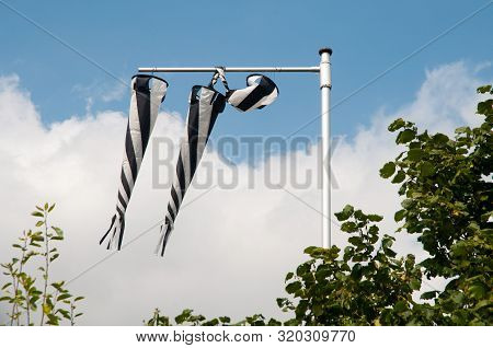 Wind Socks Striped Black And White Indicating Weak Wind On Sunny Day