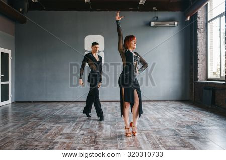 Man and woman on ballrom dance training in class