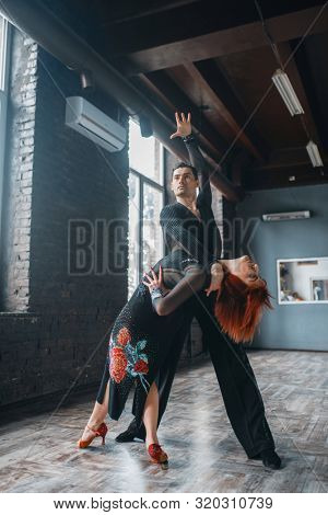 Man and woman on ballrom dance training in class