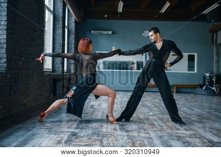 Two dancers in costumes on ballrom dance training