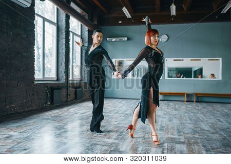 Two dancers in costumes on ballrom dance training