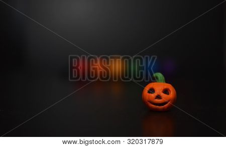 Lgbt Colored Beads And Halloween Pumpkin On Black Background Soft Focus