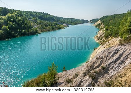 Panorama Of Chalkpit On Limestone Coast Of Huge Turquoise Lake Or River Near Forest. Chalk Quarry Fi