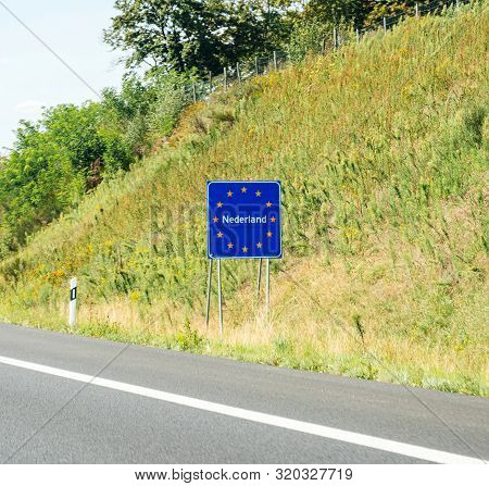 Nederland Text At The Border Between Germany And Netherlands With Text On The Road Sign With Europea