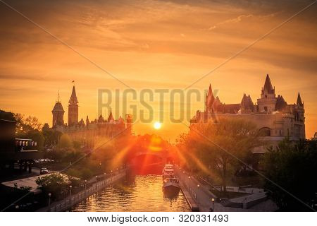 View Of Ottawa City Buildings And Rideau Canal From Mackenzie King Bridge During Sunset