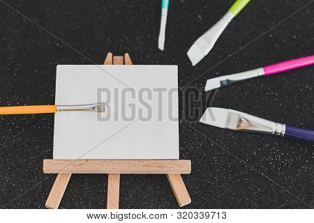 Mini Blank Canvas And Paintbrush With Copyspace