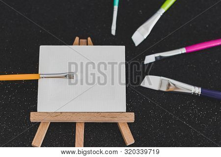 Mini Blank Canvas And Paintbrush With Copyspace