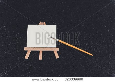 Mini Blank Canvas And Paintbrush With Copyspace