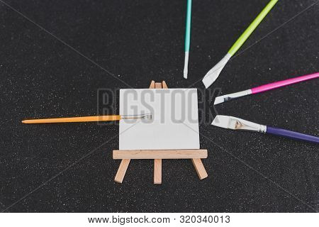 Mini Blank Canvas And Paintbrush With Copyspace