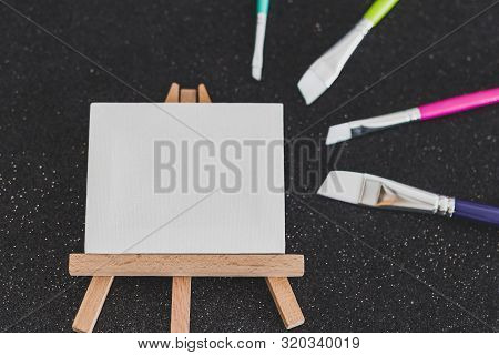 Mini Blank Canvas And Paintbrush With Copyspace
