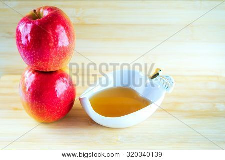 Jewish Holiday Rosh Hashana Background With Honey And Apple On Wooden Table. During The Jewish New Y